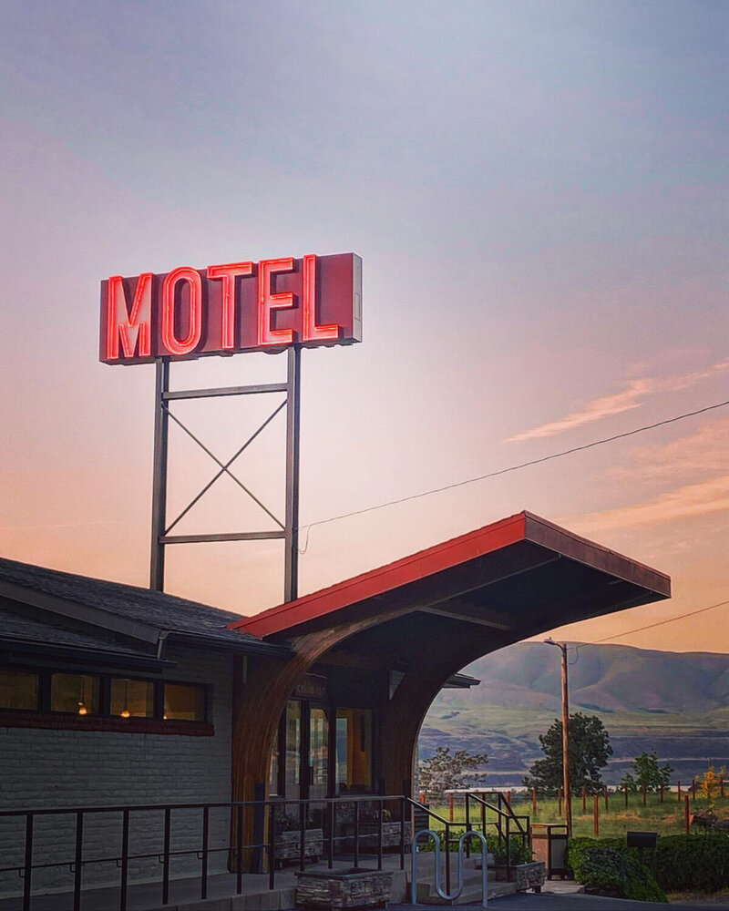 Red motel sign in front of a sunset at Celilo Inn in the Oregon Gorge