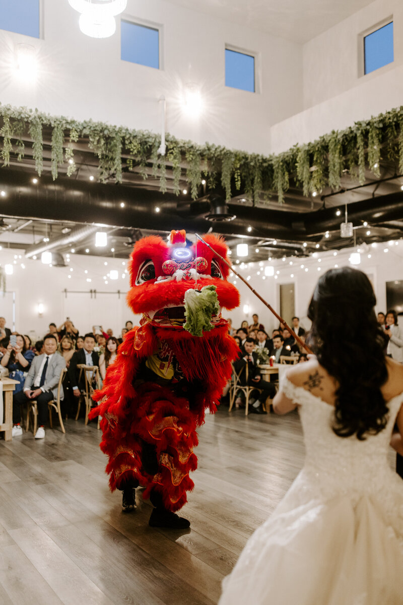 A bride watches a performance at her wedding