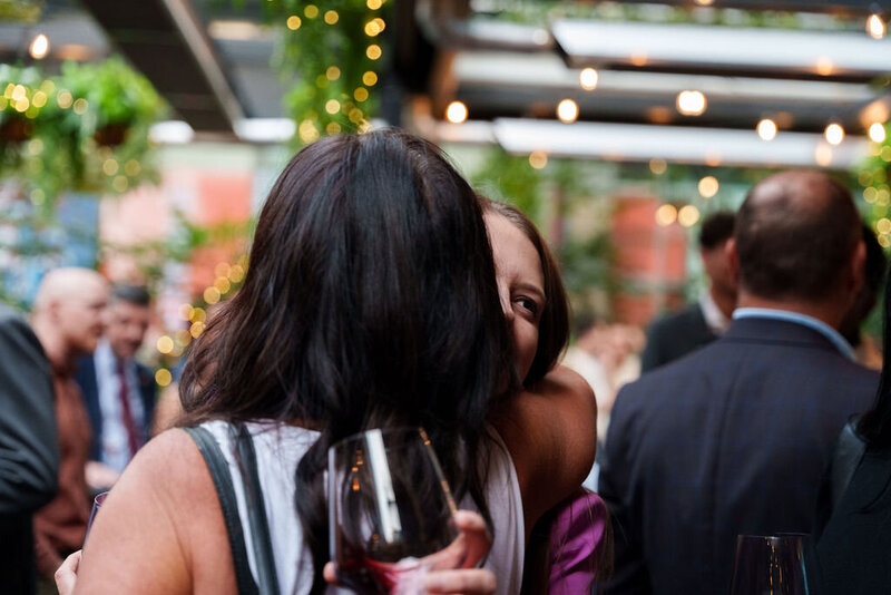 friends hugging at wine tasting of California red wine
