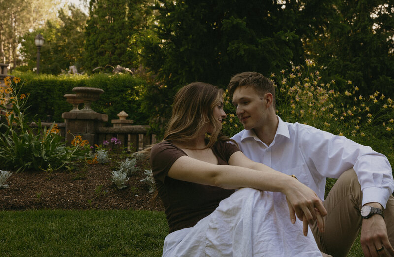 A couple dances in front of a vintage car outside.
