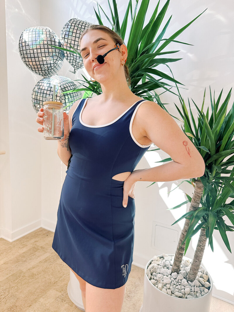 woman wearing navy cream yoga and true40 tennis dress