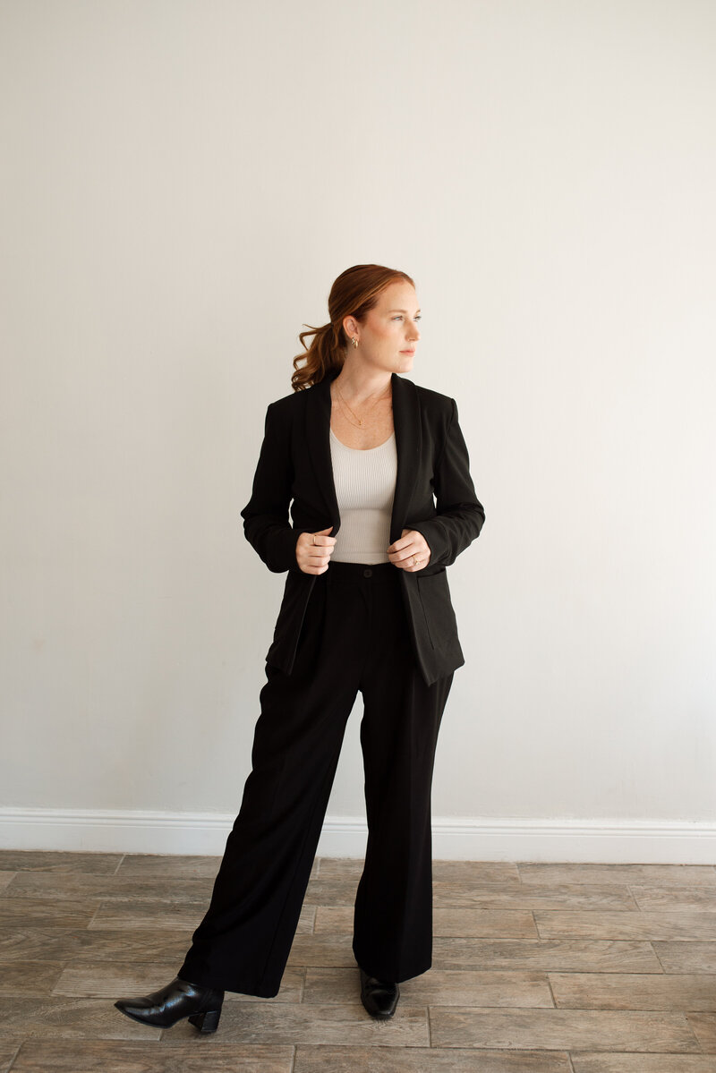 Portraits of a wedding photographer in a blazer and boots