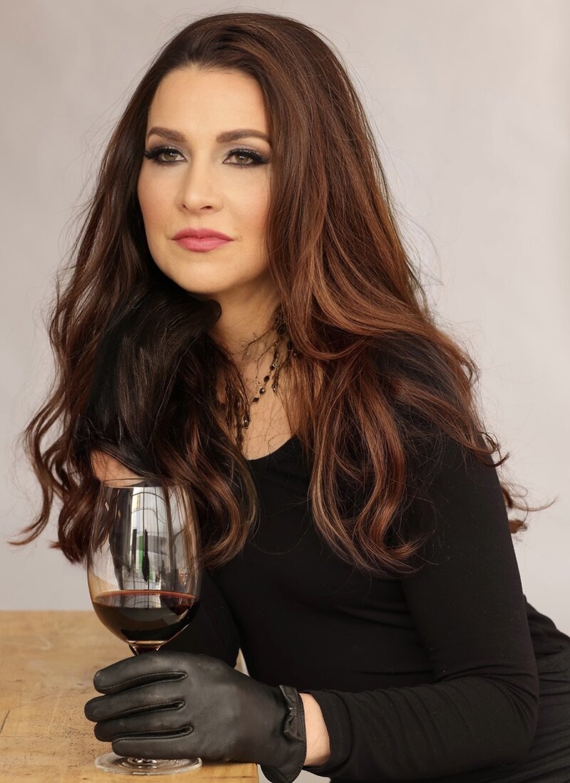 Susan Elizabeth with black dress and wine glass