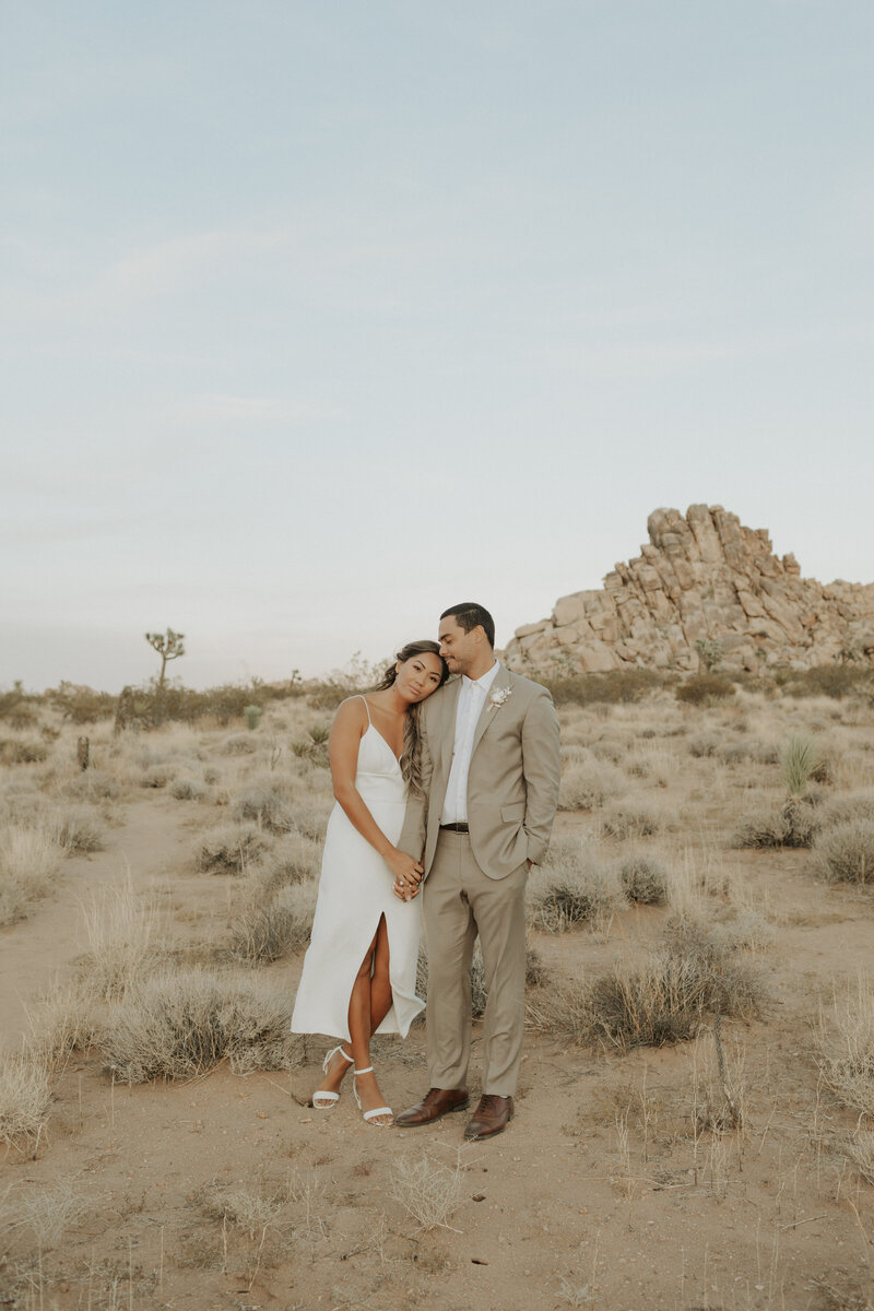 Couple standing holding hands in Joshua Tree National Park