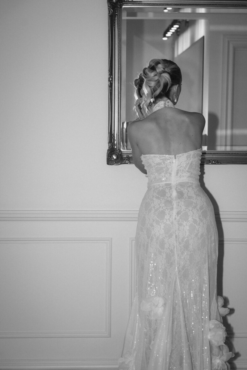Bride back of dress and mirror black and white photo