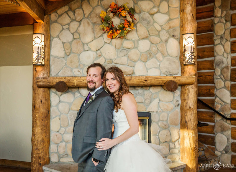Stone hearth fireplace wedding portrait at the rustic Lodge at Breckenridge in Colorado