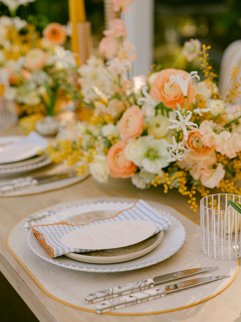 Basking in the golden glow of a citrus summer at the iconic Bahia Resort in San Diego, I had the absolute pleasure of capturing a scene of serene elegance. Tucked away in a secluded tropical garden, a charming pergola set the stage for beautifully arranged florals and meticulously styled table settings—a true mid-century retreat infused with modern whimsy. Every detail, from the vibrant citrus accents to the delicate blossoms, spoke of timeless sophistication and effortless charm. 