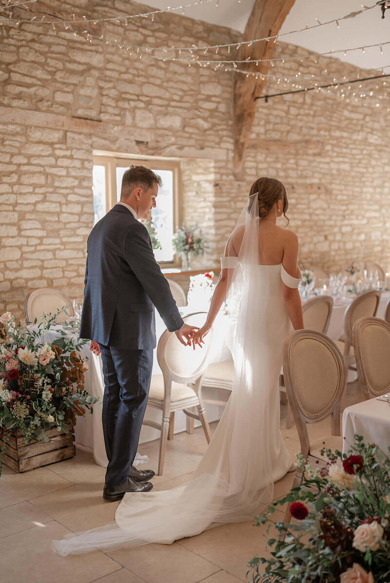 Bride and groom admiring the indoor wedding reception décor at Caswell House