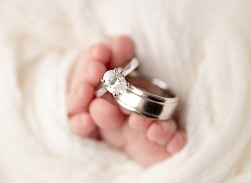 baby feet with wedding rings