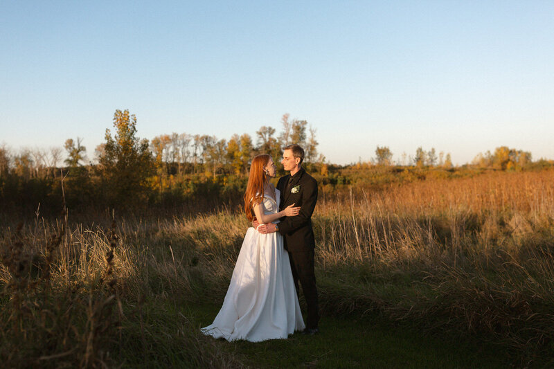 Bride and groom at sunset in a field in Manitoba