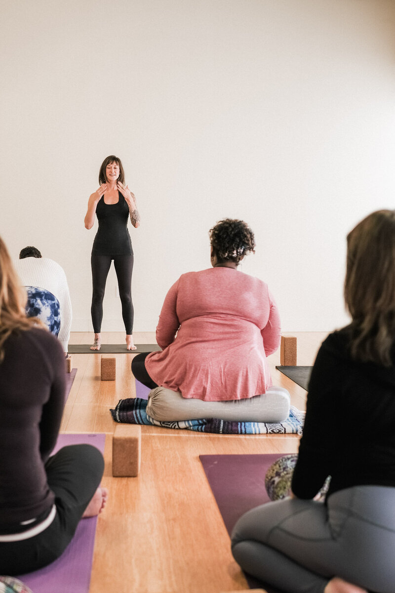 Woman teaching yoga class