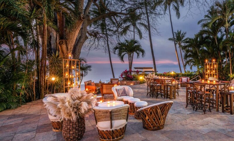 Romantic outdoor reception setup at Hyatt Ziva in Puerto Vallarta with string lights and sunset ambiance
