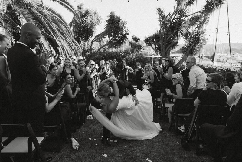 groom kissing brides neck while she tilts her head back