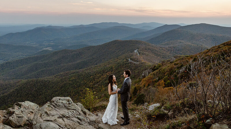 A couple holding hands on a canyon overlook