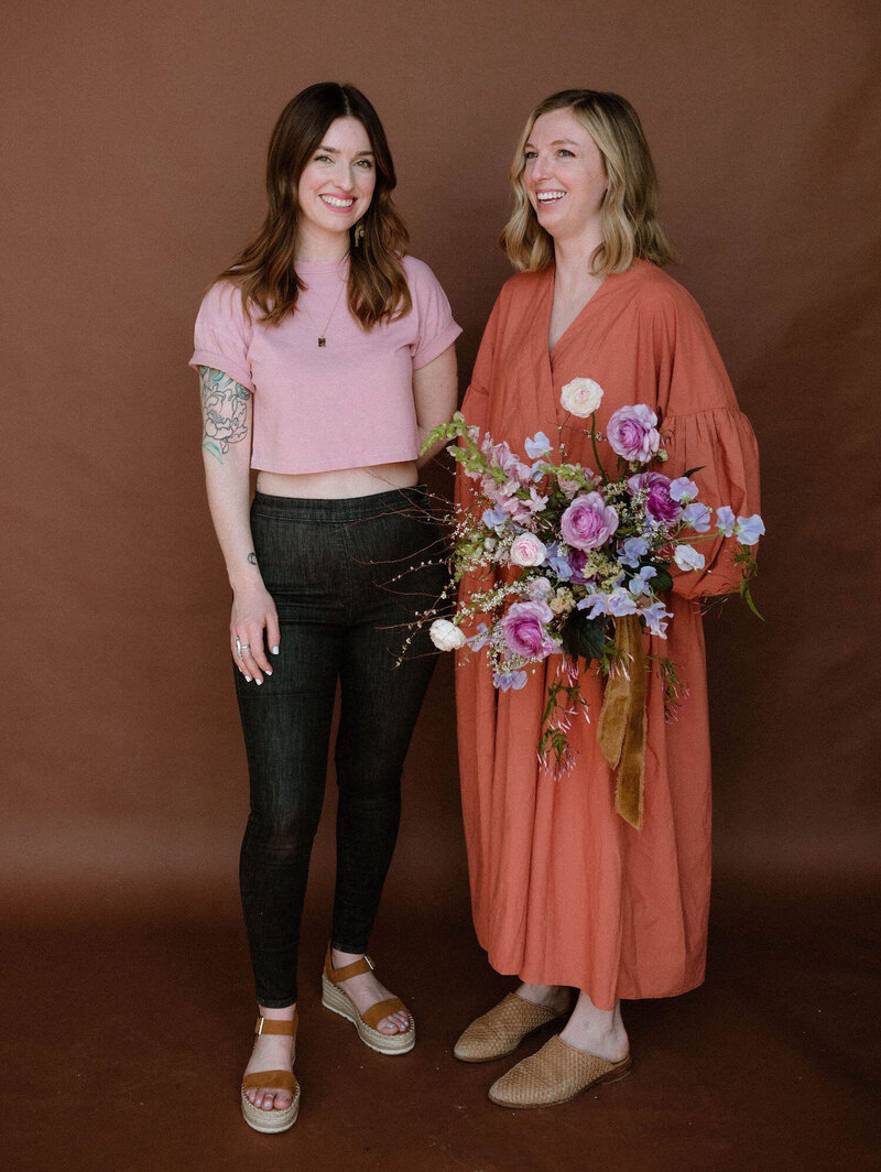 Katie and Jenny of Anthousai Florals in Tulsa, Oklahoma. Katie is holding a bouquet arrangement.