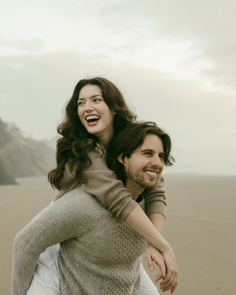 Couple laughing on moody beach