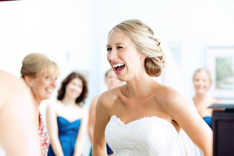 Bride laughs with bridesmaids in background, Old Mill, Rose Valley, Pennsylvania