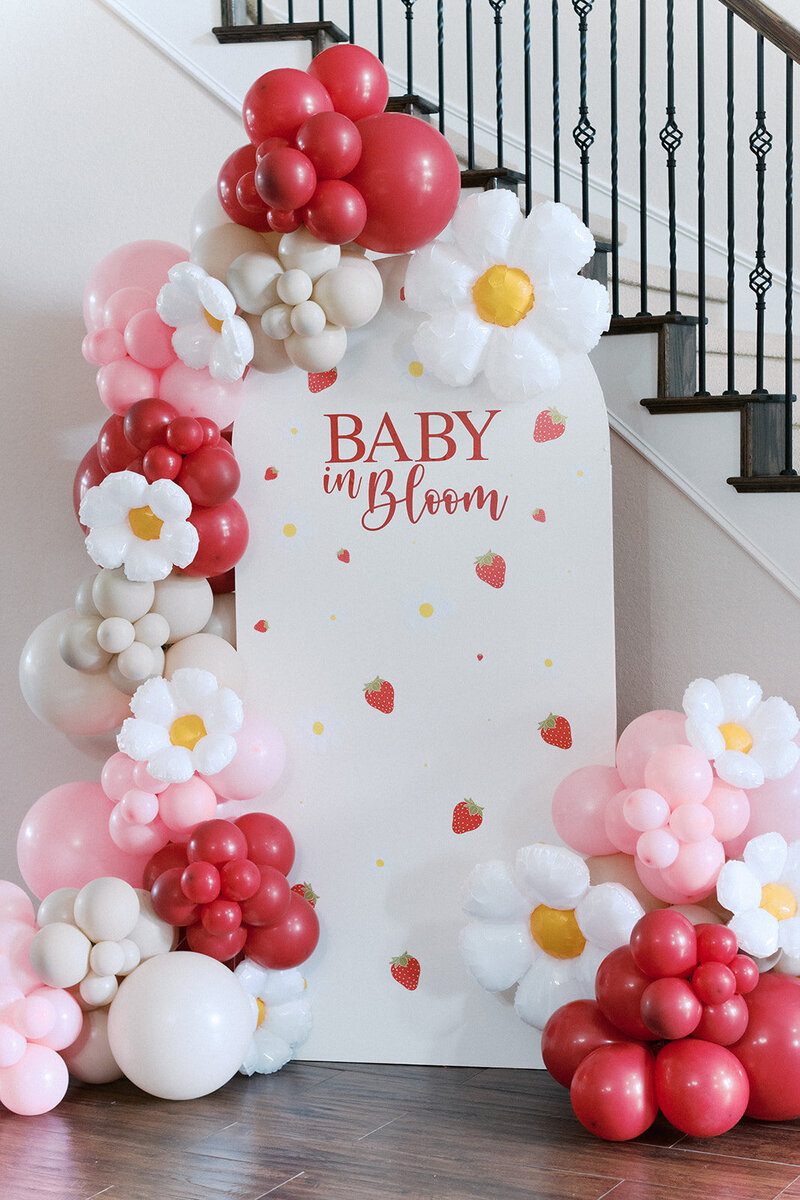 Balloon arch for floral themed baby birthday party planned by Bianca Nichole and Co