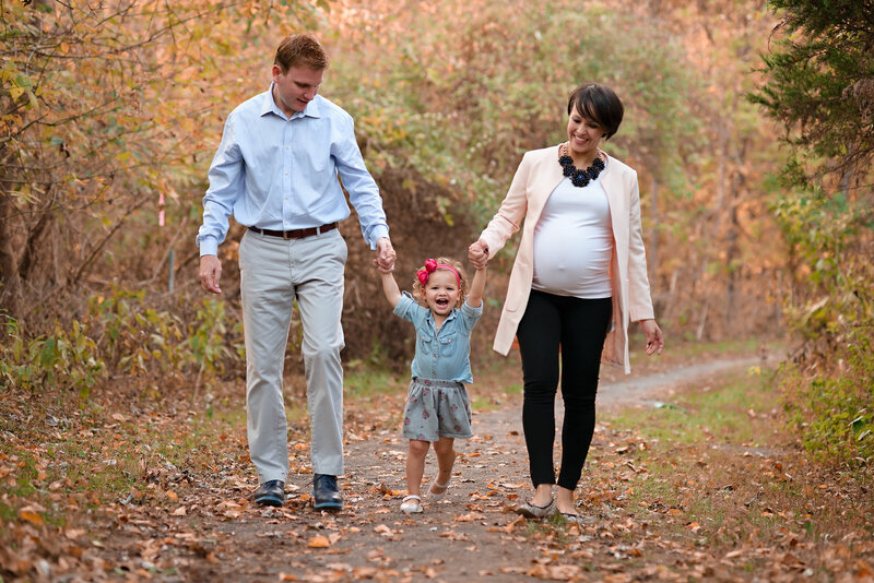 Growing family of 3 taking a walk and have their family portrait taken in the fall.  Photo taken by Dripping Springs Texas based Lydia Teague Photography.