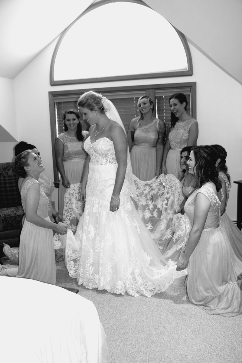 Bride in wedding dress with bridesmaids | Sugarloaf, Maine Wedding Photography
