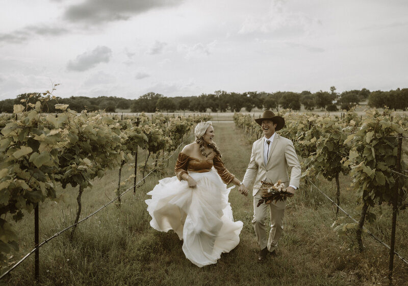 lovers skipping through the vines at the vineyard of florence