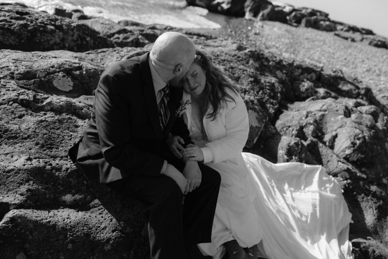 Couple snuggling up together on the beach in Tofte, MN