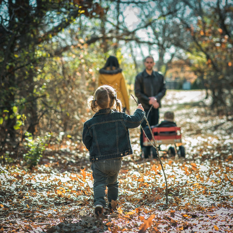 family walking in leaves