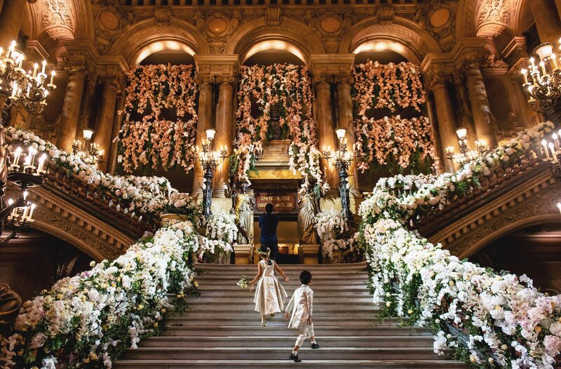 Ornate stairs with white flowers on the railings