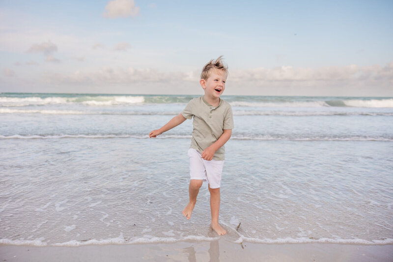 boy dances during family photo shoot in St. Pete, FL with St. Pete family photographer