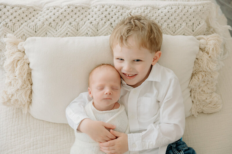 big brother holding newborn baby at Pittsburgh newborn photos