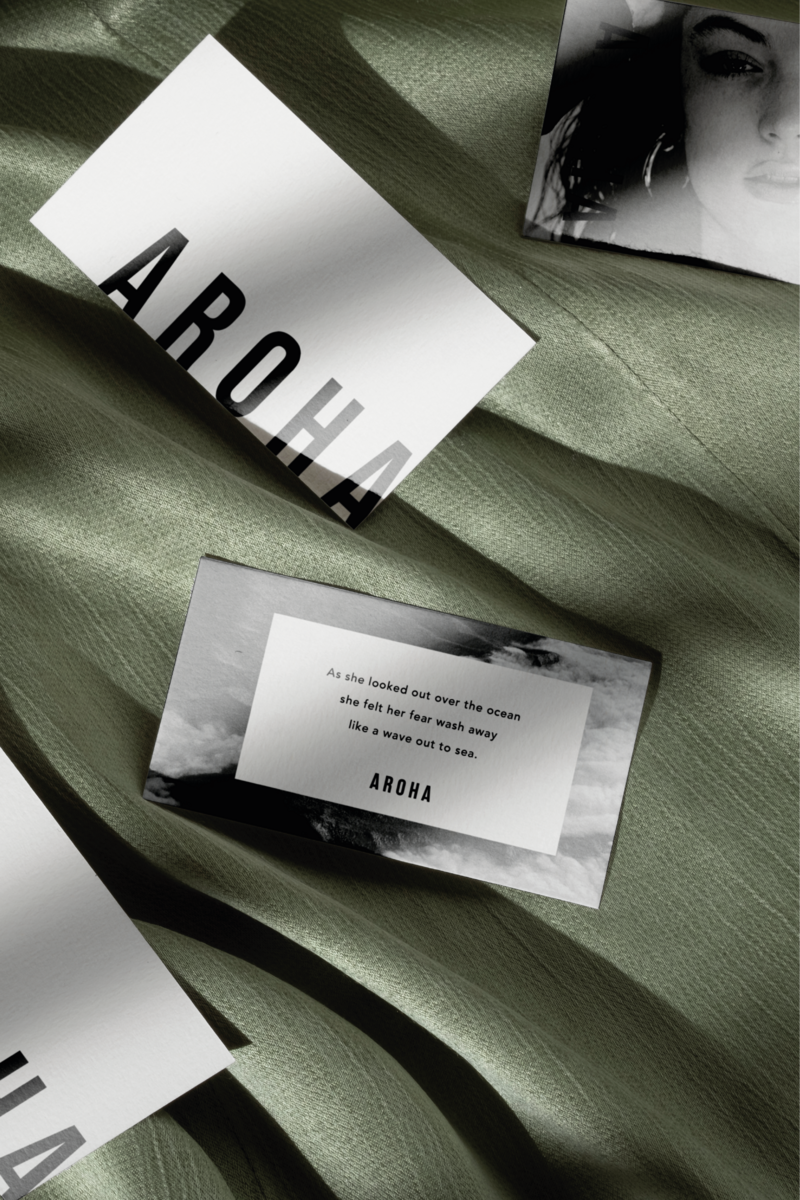 Business cards for jewellery brand laid on top of green silk