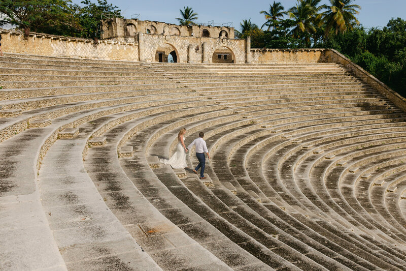 bride and groom walking down large outdoor stairs