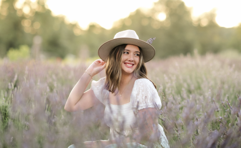 High school senior posing in a lavender field during sunset senior photo session in York, Pennsylvania.