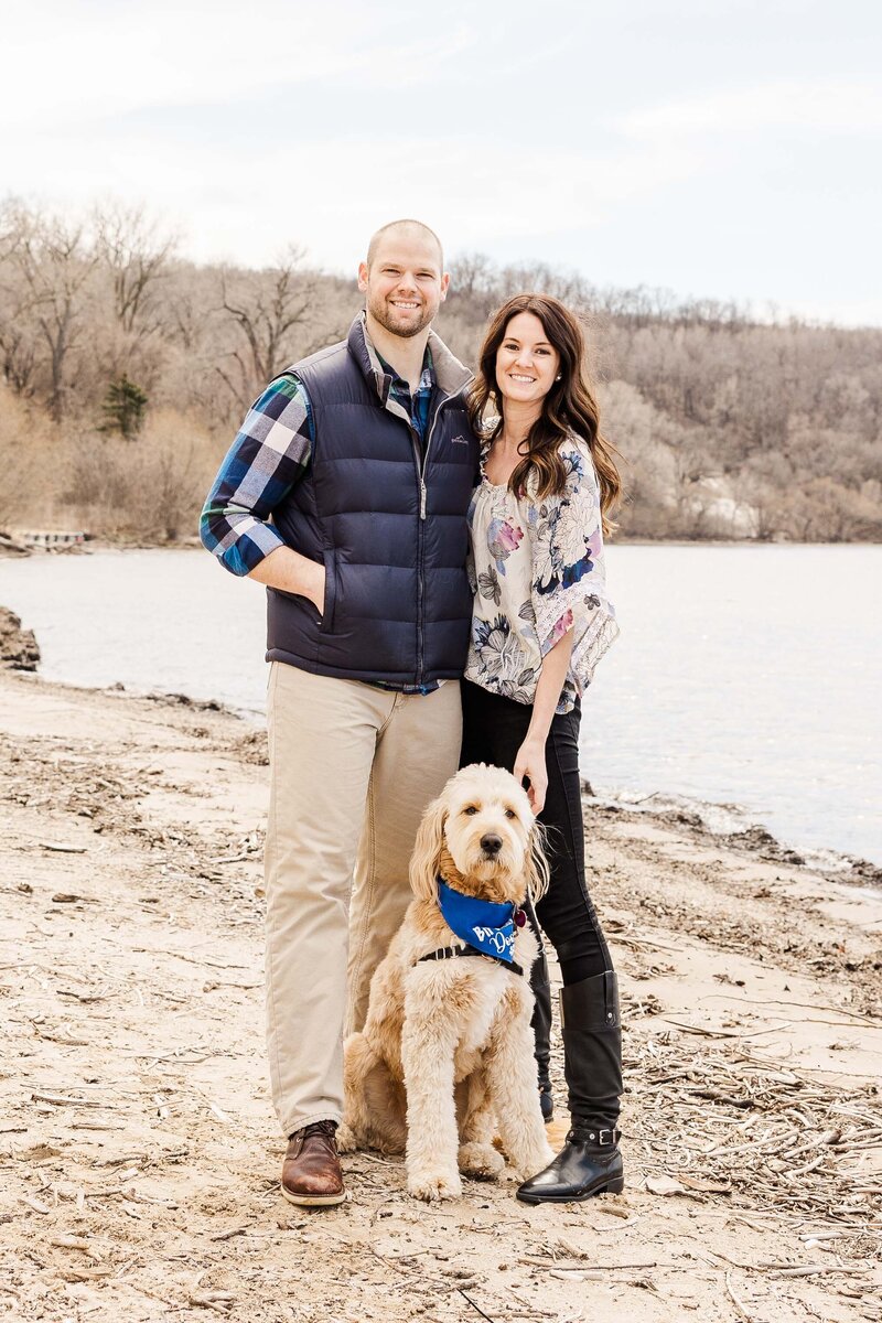 Goldendoodle with pet parents in front of lake outside of Milwaukee, Wisconsin.  Milwaukee Wisconsin Photographer.