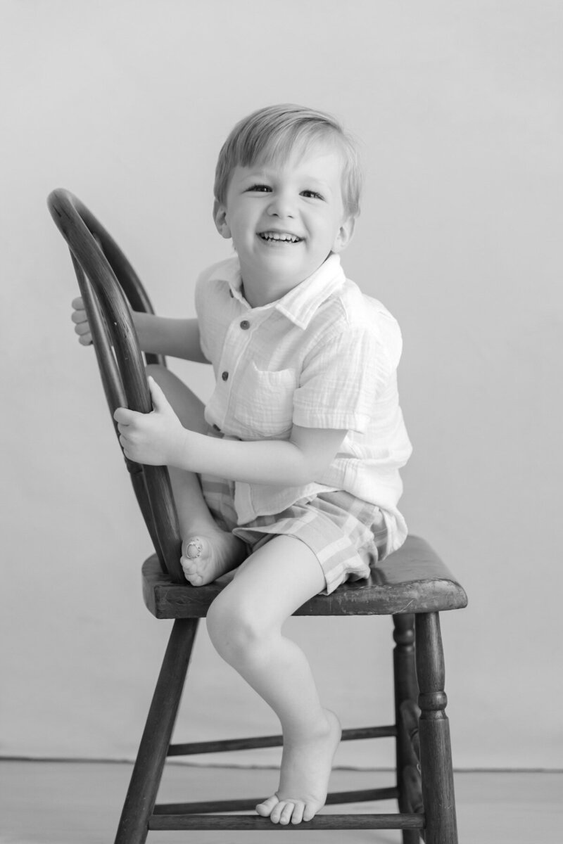 Little boy smiles playfully during his Personality Portrait photo session in Raleigh by Christy Johnson Photography