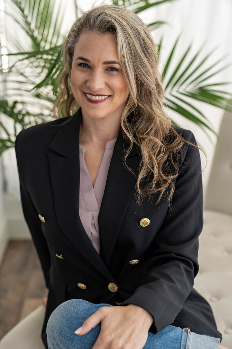 woman smiling at camera in a blazer