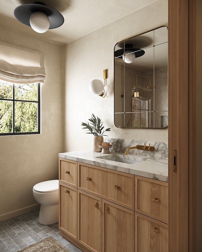 Light-filled organic modern bathroom with natural wood vanity, marble countertop, brushed brass fixtures, and grid mirror. Features neutral plaster walls, linen roman shade, and a sleek wall-mounted faucet.