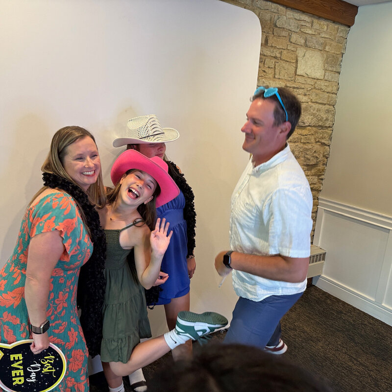 Group laughing and posing at photo booth