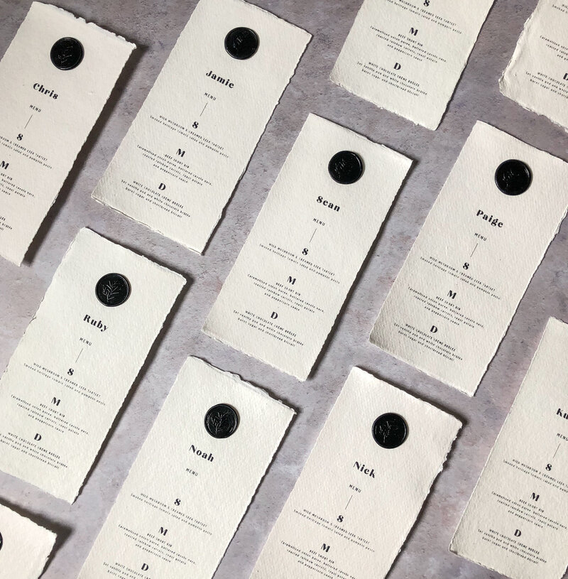 Flatlay image of digital printing on handmade paper with black wax seal