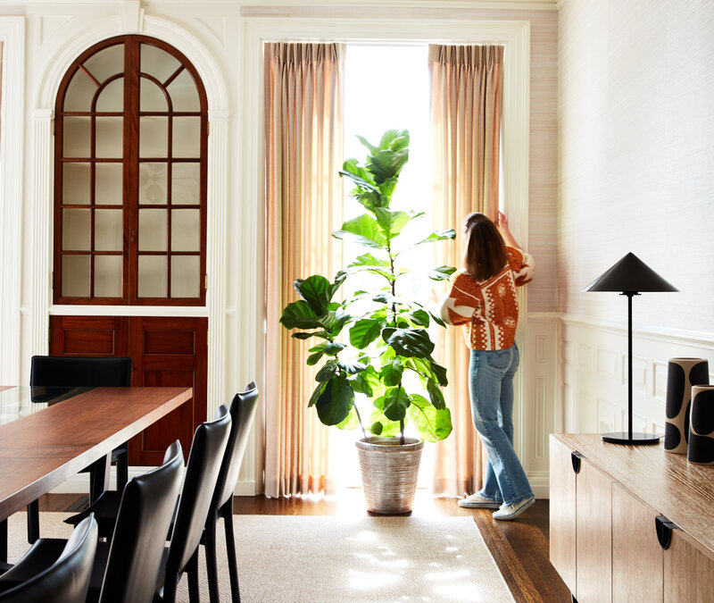 Boston interior decorator Sarah Scales historic home design in Concord features a dining room with original millwork, modern lighting, and custom furnishings.