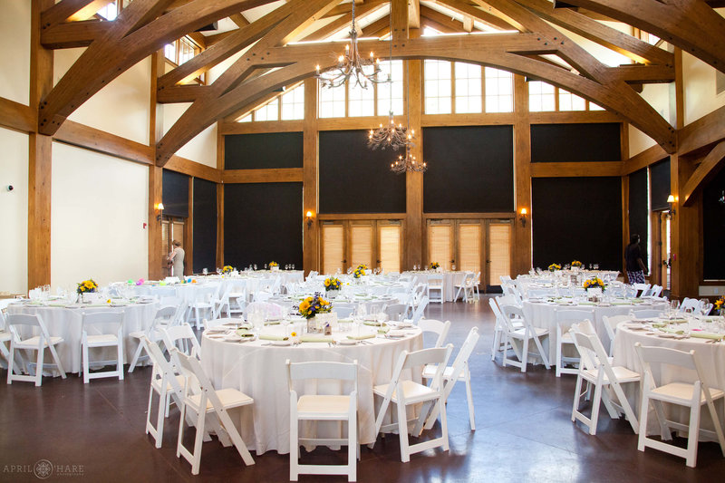 Interior of Donovan Pavilion set up with white tables and chairs with the window shades pulled down in Vail Colorado