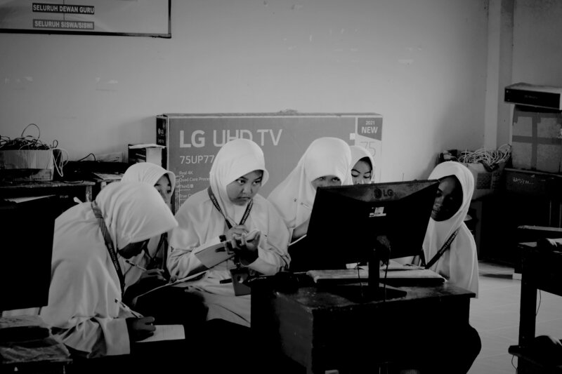 girls learning from watching a screen
