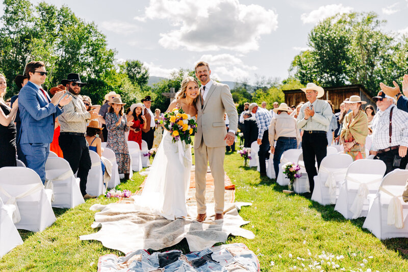Bride and groom ceremony exit at Staubach Creek Ranch in Winston, MT
