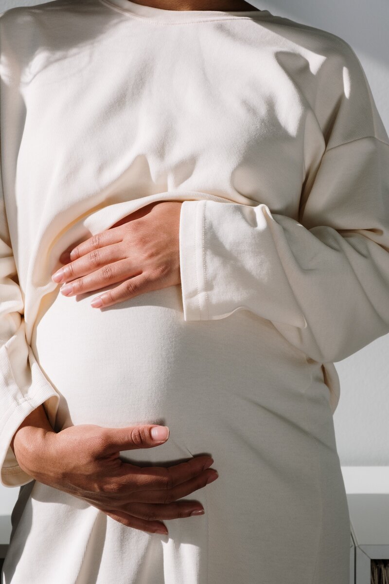 pregnant woman holding her stomach