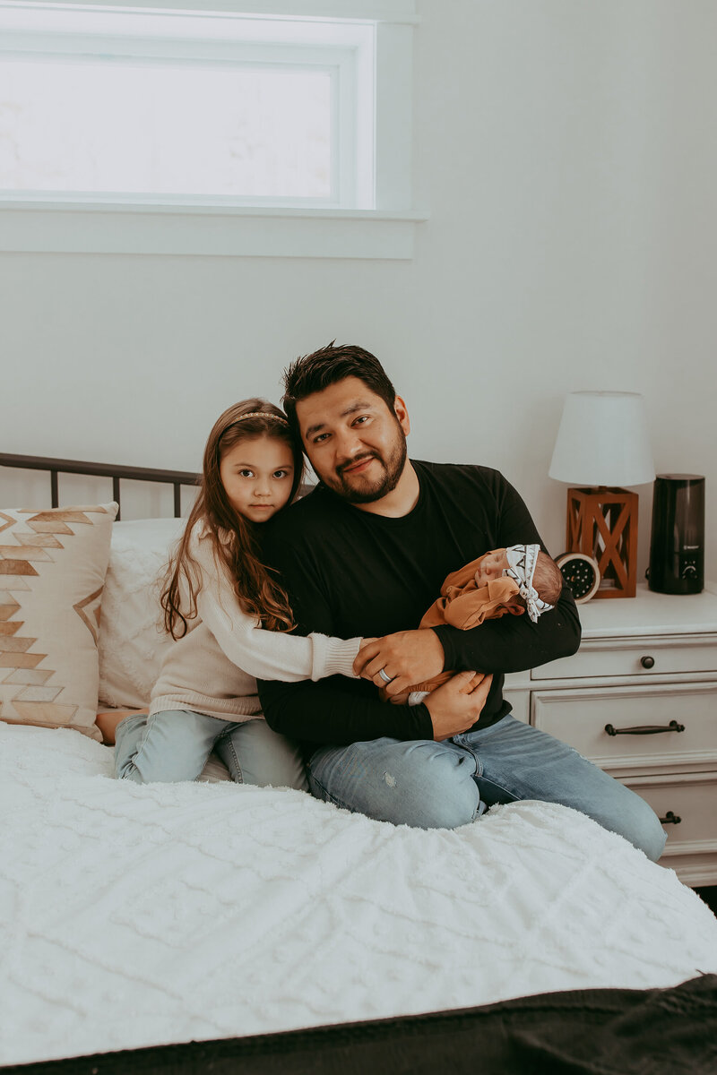 dad-holding-baby-with-daughter