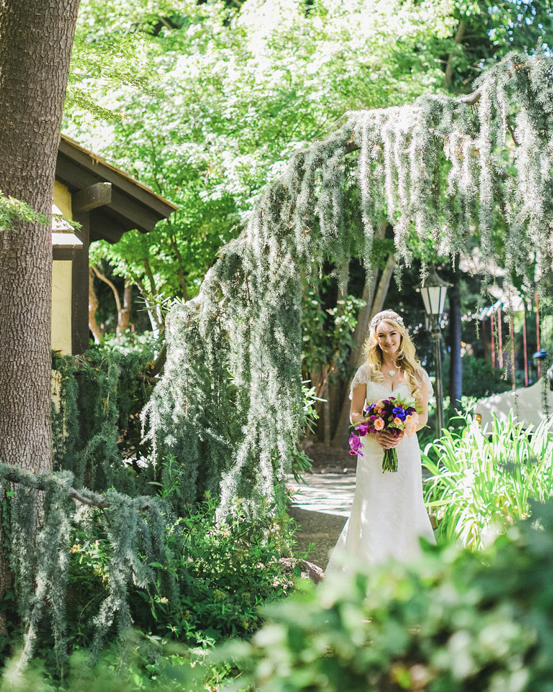 Portrait of Bride standing in greenery