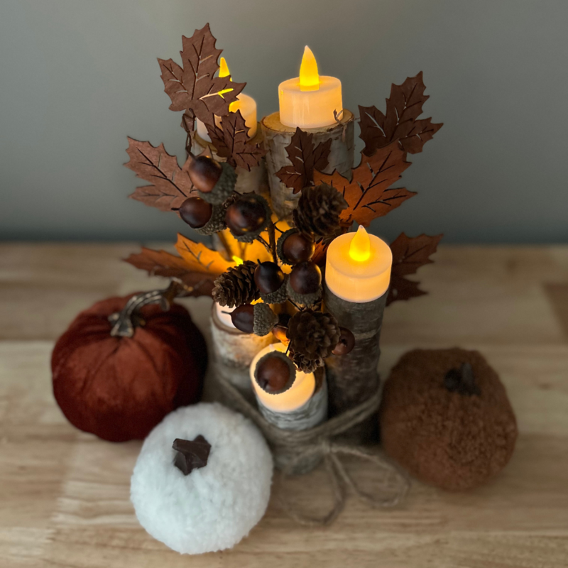 Autumn centerpiece design with pumpkins, leaves & candles