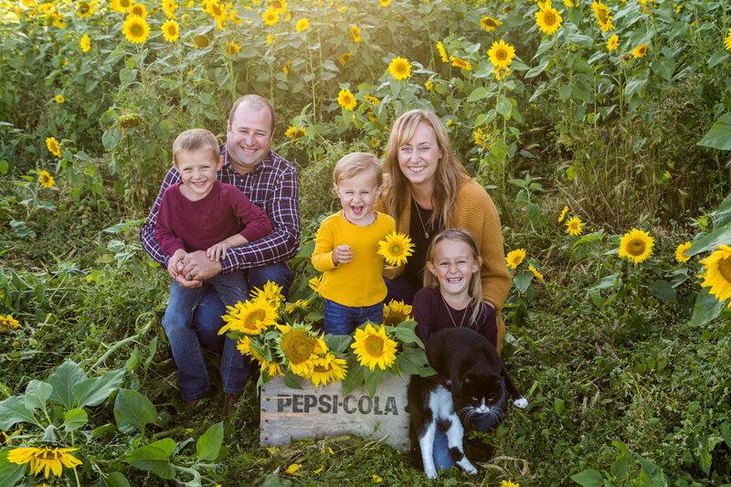 family of 5 in sunflower field