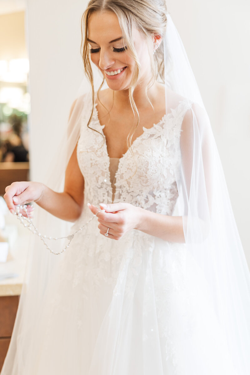 bride in a lace wedding dress with a sheer veil
