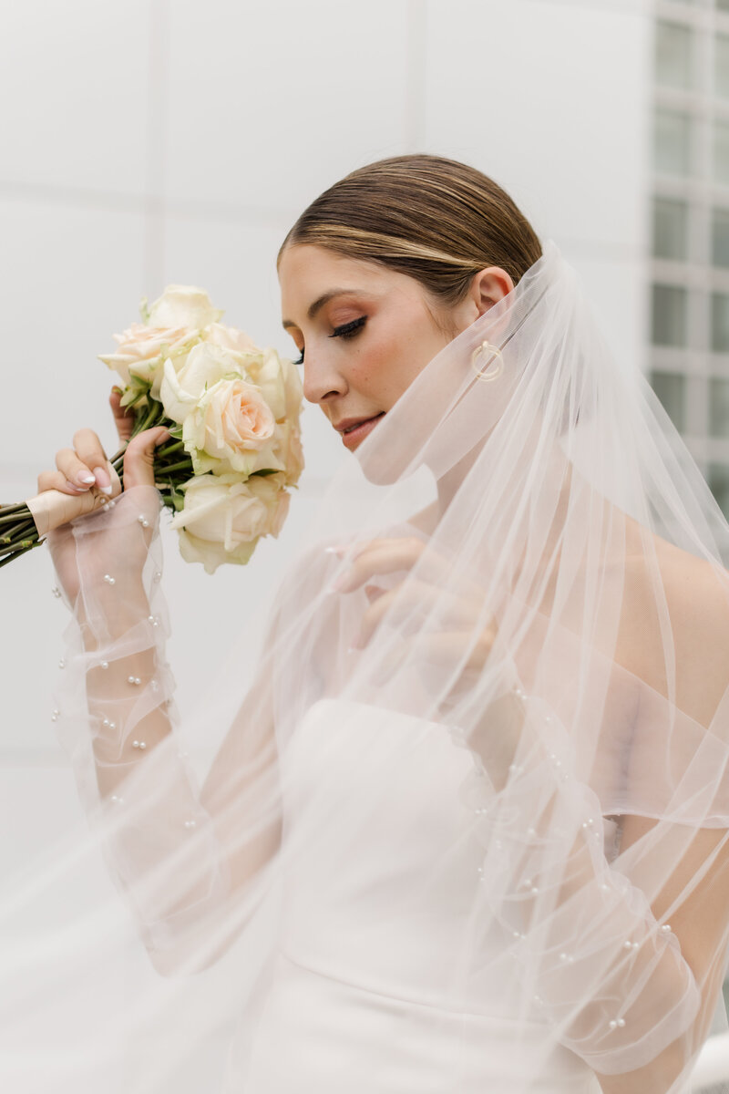 bride wearing veil and holding bridal bouquet